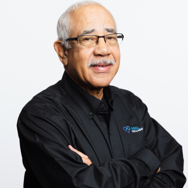 Senior man with glasses wearing a black shirt, smiling.